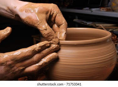 hands of a potter, creating an earthen jar on the circle - Powered by Shutterstock