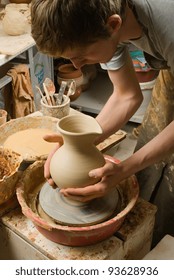 hands of a potter, creating an earthen jar of white clay
