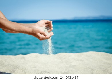 hands pouring sand near the seashore on weekend nature travel - Powered by Shutterstock