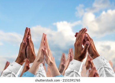 Hands in prayer against the sky. Dlured background. The concept of religious beliefs, confessions, worship. - Shutterstock ID 2151591765