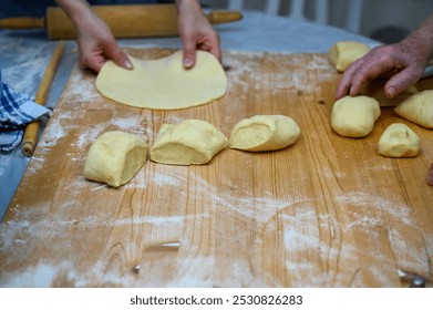 Hands Preparing Dough on a Floured Wooden Surface for Baking - Powered by Shutterstock