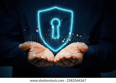 Hands presenting a glowing shield with a lock keyhole, virtual light effects, abstract style, dark background. Concept of cybersecurity