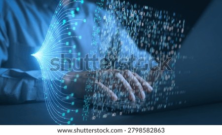 Hands of a programmer typing on a laptop keyboard with glowing digital data streams and binary code overlay. Concept of big data management, AI technology, and advanced software development.
