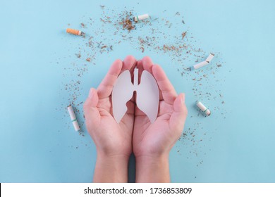 Hands protect lungs from cigarette on light blue background. Stop smoking. World No Tobacco Day concept. Copy space for advertisers.