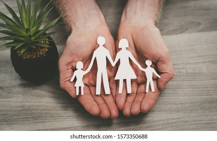 Hands protecting a family; symbol of life insurance