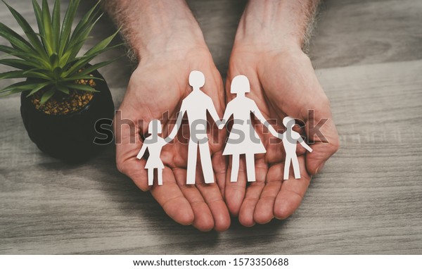 Hands\
protecting a family; symbol of life\
insurance