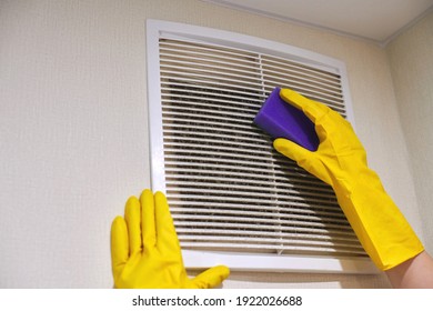 Hands In Protective Rubber Gloves Cleaning Dusty Air Ventilation Grill Of HVAC. Cleaning Service Concept.