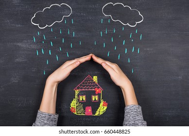 Hands Protects A House From The Elements - Rain Or Storm