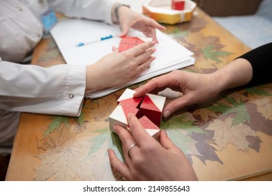 The hands of a psychologist doctor and the patient's hands. Psychologist conducts a test with cubes.The psychologist identifies problems. - Shutterstock ID 2149855643