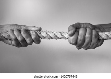 Hands pulling rope playing tug of war, people competitive, dispute, contest concept.  - Shutterstock ID 1420759448