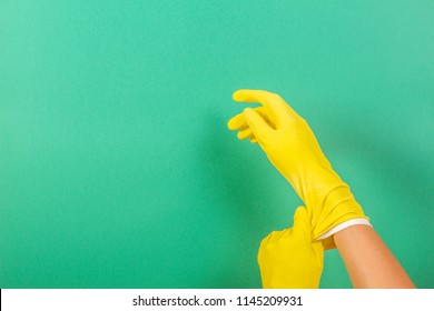 Hands Putting On Yellow Rubber Gloves