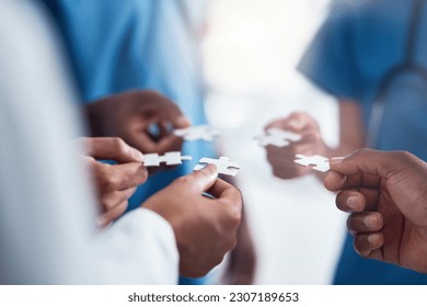 Hands, puzzle and collaboration of medical doctors in hospital for team building, synergy and planning. Teamwork, nurses and jigsaw pieces for healthcare, solution and strategy, cooperation and trust - Powered by Shutterstock