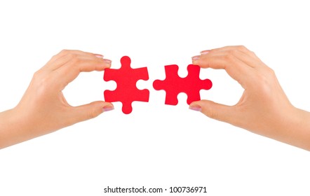 Hands and puzzle isolated on white background - Shutterstock ID 100736971