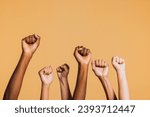 Hands raised with closed fists. Diverse coloured hands raised up with closed fist symbolizing power, determination.