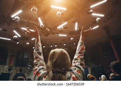 Hands Raised In The Crowd. A Group Of People Stretches Out Their Hands. Bright Lighting. Personal Growth Training. Warm-up For The Audience - All Raised Their Hands Up And Reach Up