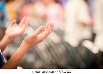 Hands raised like praying or worshiping