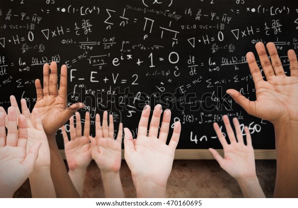 Hands\
raising in the air against blackboard on\
wall