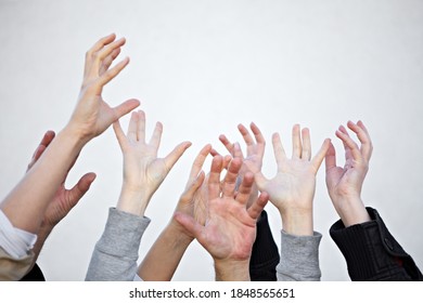 A Lot Of Hands Reach Up