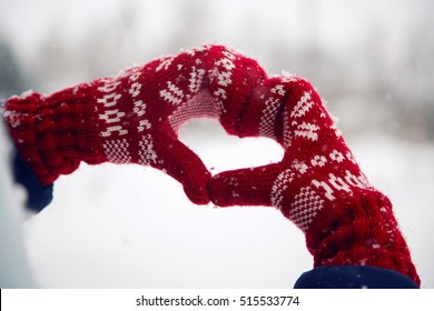 Hands In Red Mittens Folded Heart In Snow Winter