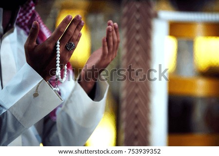 Hands of a religious man praying inside the mosque. tasbih, hands.