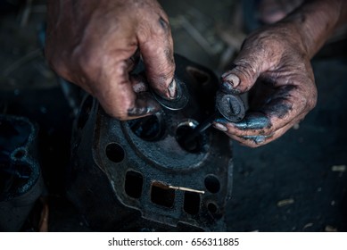 Hands repairing a engine