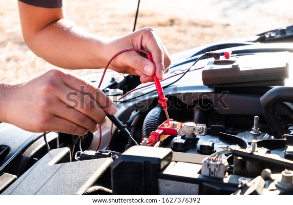 The hands of the repairman are checking the
order of the engine using modern
tools.