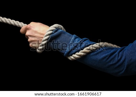 hands with a rope on a black background