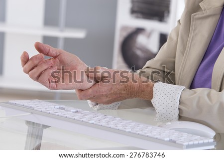 Hands with RSI syndrome over the keyboard of laptop computer