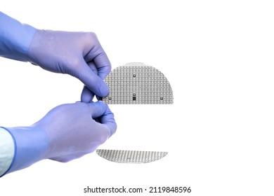 A Hands In A Rubber Glove Hold Broken Multilayer Semiconductor Silicon Wafer With A Microcircuit Chip Of A Powerful Darlington Transistor Isolated On A White Background.