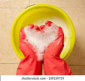 Hands With Rubber Gloves Holding A Heart Shaped Foam