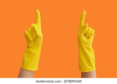 Hands In Rubber Gloves Pointing At Something On Color Background