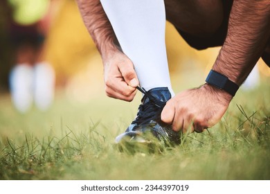 Hands, rugby athlete and tie shoes to start workout, exercise or fitness. Sports, player and man tying boots in training preparation, game or competition for healthy body or wellness on field outdoor - Powered by Shutterstock