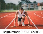 Hands runner ready start to run athlete sportman training run on lane at the stadium in morning. Runner man wearing white vest to practice running prepare for competition race.