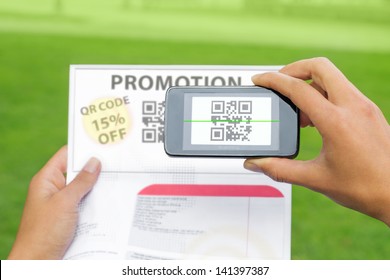 Hands Scanning Qr Code From Coupon