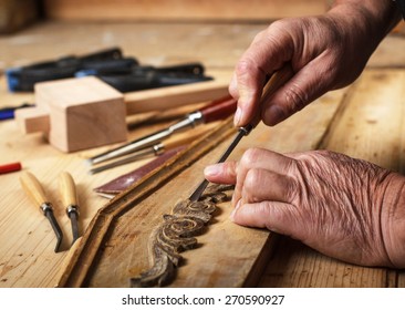 The Hands Of An Senior Carpenter Restoring Old Furniture, Close-up.
