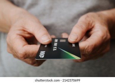 Hands Of Senior Caucasian Woman Holding Bank Card Mir Of Russian Payment System, Close-up. Selective Focus On The Logo. Smolensk, Russia 02.04.2022.