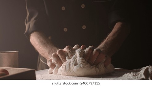 Hands of senior experienced chef kneading floured dough at bakery, old man making homemade bread using traditional methods, isolated on black background closeup  - Powered by Shutterstock