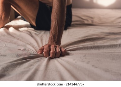 Hands Of Senior Man Squeezing The Sheets To Relieve Stress Sitting On In The Old Rent Room, Stress During Pandemic And No Job, Economic Downturn Due To Covid, Depression And Mental Health Concept.