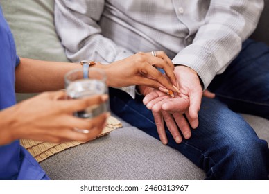 Hands, senior patient and nurse with pills for alzheimer, arthritis or parkinson disease on sofa. House, elderly man and caregiver for helping, assistance and medicine for old person in living room - Powered by Shutterstock