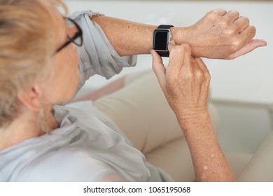 Hands Of Senior Woman Checking Her Smartwatch