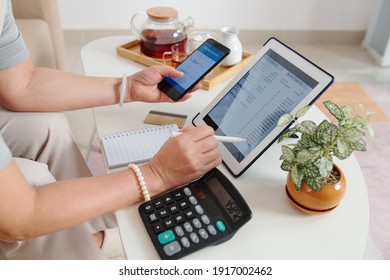 Hands Of Senior Woman Checking Investment Account Via Application On Tablet Computer And Buying New Stocks And Receiving Dividends