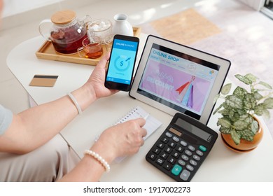 Hands of senior woman shopping in online store on sale and paying for purchases with mobile application