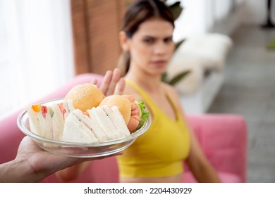 Hands Serving Food And Young Caucasian Woman Making Sign Say No Food Unhealthy With Obese, Woman Refuse And Push Out Food With Temptation For Dieting, Nutrition And Fast Food A Bad, Health Concepts.