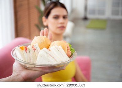 Hands Serving Food And Young Caucasian Woman Making Sign Say No Food Unhealthy With Obese, Woman Refuse And Push Out Food With Temptation For Dieting, Nutrition And Fast Food A Bad, Health Concepts.