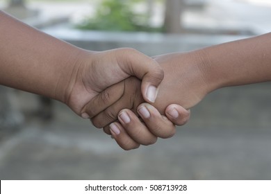 hands shake over nature background