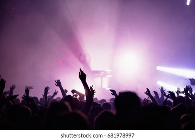 Hands silhouette in the air in summer music festival - lila color in background - Shutterstock ID 681978997