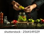 Hands skillfully prepare colorful peppers in a dimly lit kitchen. Fresh garlic, herbs, and spices enhance the artistry of cooking. A flavorful creation is on the way, highlighting culinary passion.