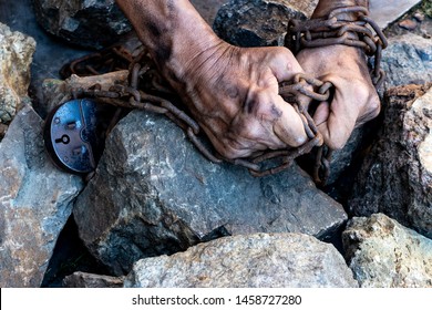 The hands of a slave in an attempt to release. The symbol of slave labor. Hands in chains