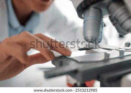 Hands, slide and science closeup for microscope, biotechnology and monkeypox vaccine development. Scientist person, healthcare and study for stem cell, genes editing or microbiome research in lab