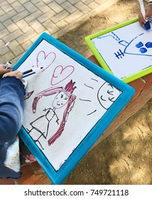 Hands small student drawing whiteboards in outdoors 